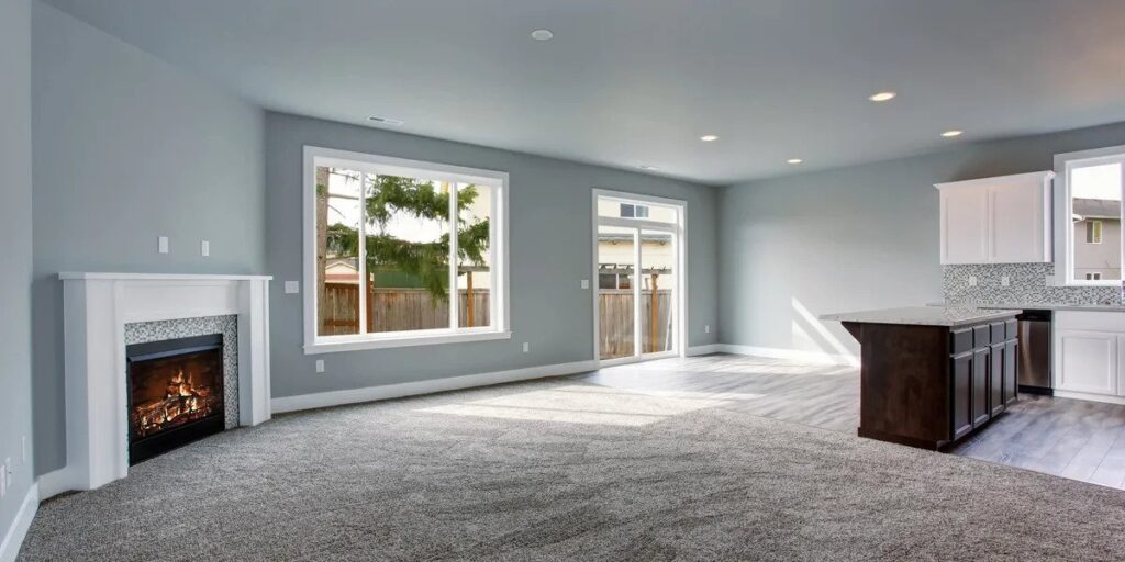 Living room with freshly vacuumed carpet and no furniture - ready for move in day